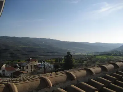 a view from the roof of a building with mountains in the background at Our House in Vavla