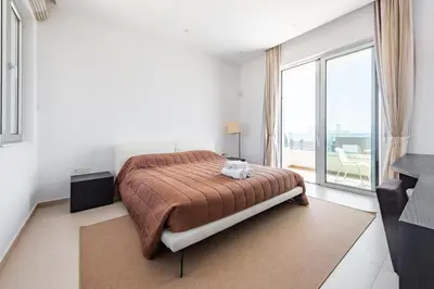 a bedroom with a bed and a large window at Villa Dione by Ruidoso Luxury in Ayia Napa