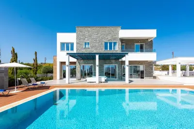 a villa with a swimming pool in front of a house at Villa Dione by Ruidoso Luxury in Ayia Napa