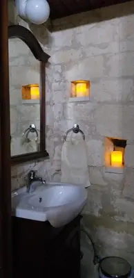 a bathroom with a sink and a mirror at Magdalous House in Arsos