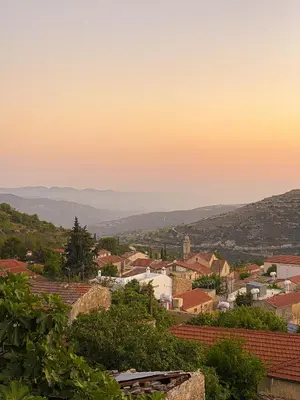 a view of a town at sunset at Magdalous House in Arsos