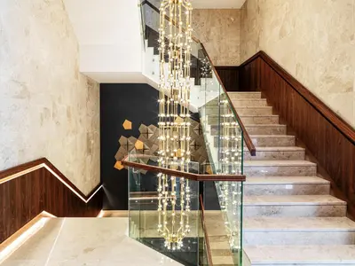 a staircase with glass railings and a glass stair case at The Tower at St Raphael Resort in Limassol