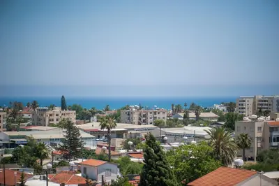 a city with buildings and the ocean in the background at Orion Apartment 401 in Larnaka