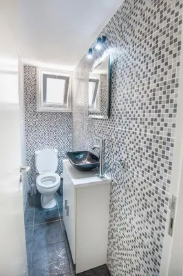 a small bathroom with a toilet and a sink at Orion Apartment 401 in Larnaka