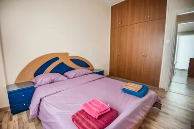 a bedroom with a bed with two towels on it at Orion Apartment 401 in Larnaka