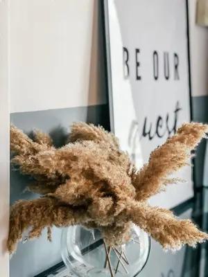a glass vase with a dried flower in it at Milea Mansion in Limassol