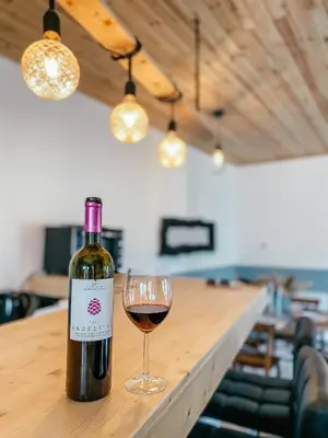 a bottle of wine sitting on a table with a glass at Milea Mansion in Limassol