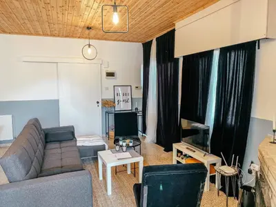 a living room with a couch and a tv at Milea Mansion in Limassol