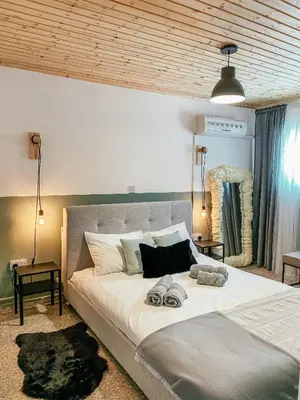 a bedroom with a large bed with two towels on it at Milea Mansion in Limassol