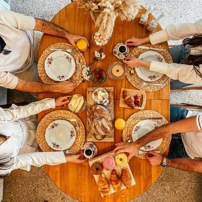 a group of people sitting around a table with food at Milea Mansion in Limassol