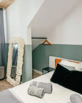 a bedroom with a white bed with a mirror at Milea Mansion in Limassol