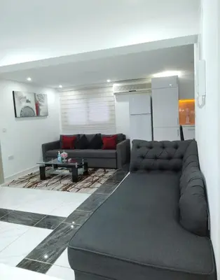 a living room with a couch and a table at Seafront - 2 bedroom Modern in Limassol