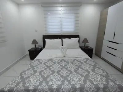 a bedroom with a large bed with two night stands at Seafront - 2 bedroom Modern in Limassol