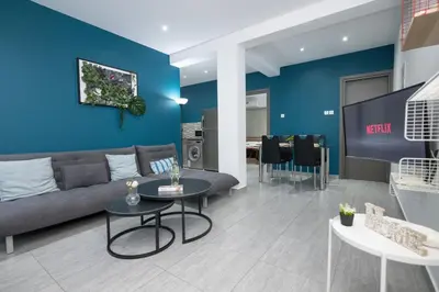 a living room with a couch and a table at Bellagio Napa Suites in Ayia Napa