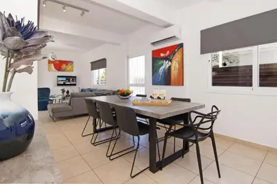 a dining room and living room with a table and chairs at Elite Luxury Villa in Paralimni