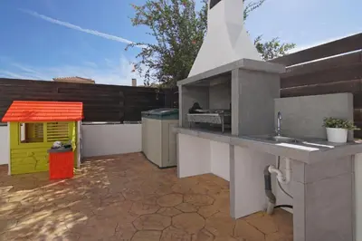 a outdoor kitchen with a sink and a dog house at Elite Luxury Villa in Paralimni