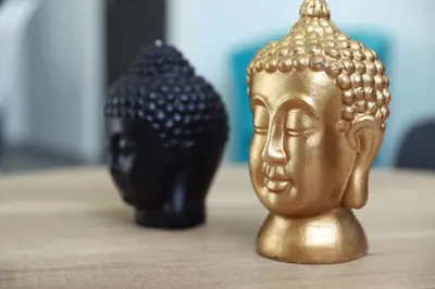 two gold buddha statues sitting on a table at Ayia Napa Boutique Apartments in Ayia Napa