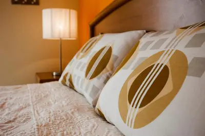 a bed with four pillows on top of it at Limassol Hestia Boutique Apartment in Limassol