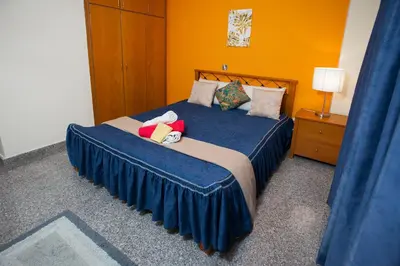 a bed with two stuffed animals on it in a room at Limassol Hestia Boutique Apartment in Limassol