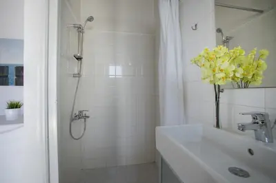a white bathroom with a sink and a shower at Villa in Ayia Napa with a pool! in Ayia Napa