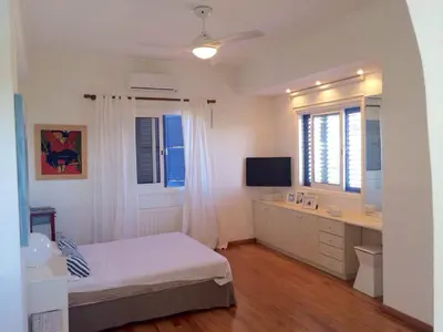 a bedroom with a bed and a desk and a television at Villa in Ayia Napa with a pool! in Ayia Napa