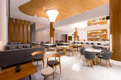 a restaurant with tables and chairs and a bar at Radisson Beach Resort Larnaca in Larnaka