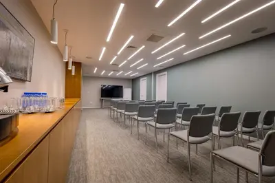 a conference room with a row of chairs and a podium at Radisson Beach Resort Larnaca in Larnaka