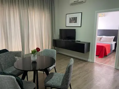 a living room with a table and chairs and a bed at A.V Central Apartment in Larnaka