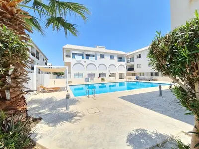 a swimming pool in front of a building at Lovely Studio Ayia Napa in Ayia Napa