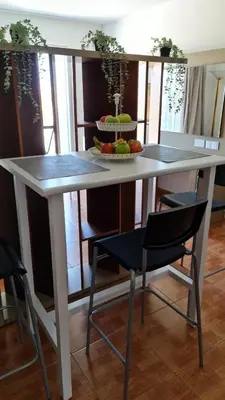 a table with a plate of fruit on top of it at Fotoxenia Luxury Apts in Paralimni