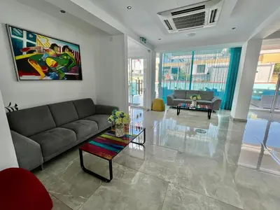 a living room with a couch and a table at Sunny Blue Hotel in Ayia Napa