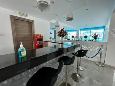 a bar with black bar stools in a room at Sunny Blue Hotel in Ayia Napa