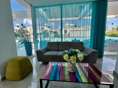 a living room with a couch and a table at Sunny Blue Hotel in Ayia Napa