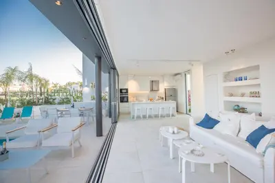a living room with a white couch and tables at The White H Villa, Protaras, Fresh and Peaceful in Paralimni