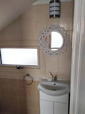 a bathroom with a sink and a mirror at KapparisVilla in Paralimni