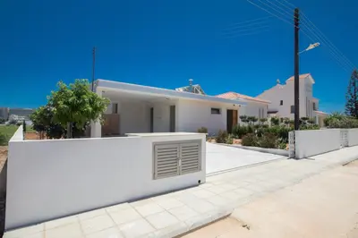 a white house with a white wall at Leda Villa in Protaras