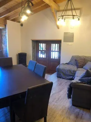 a living room with a table and a couch at To Spiti tou Faliari in Platanistasa