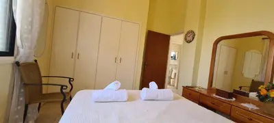 a bedroom with a bed with two white towels at STAY Swallow's Nest Villa in Ayia Napa