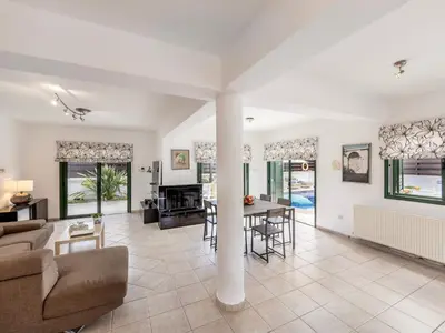 a living room with a couch and a table at Villa Eftihia in Protaras