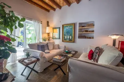 a living room with two couches and a table at Casa BOHO in Alaminos