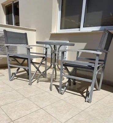 two chairs and a table and two chairs at Protaras Ionian Breeze House in Paralimni