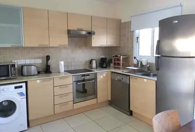 a kitchen with a stainless steel refrigerator and a dishwasher at Protaras Ionian Breeze House in Paralimni