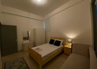 a small bedroom with a bed and a couch at Central Suites Down Town Nicosia in Nicosia