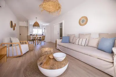 a living room with a couch and a table at KSQUARED in Protaras