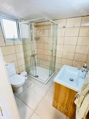 a bathroom with a shower and a toilet and a sink at Milos City Center Apts No.34 in Larnaka