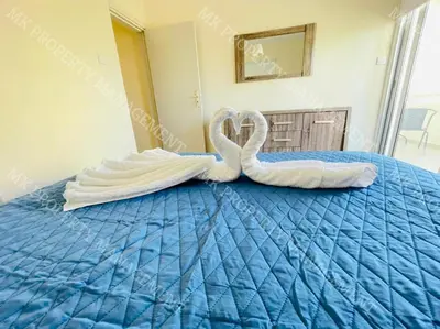 two swan towels on a bed in a bedroom at Milos City Center Apts No.34 in Larnaka