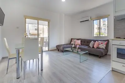 a living room with a couch and a table at Downtown Larnaca in Larnaka