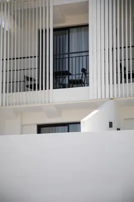 a view of the balcony of a building with a table at Alinea Urban Saripolou Square in Limassol