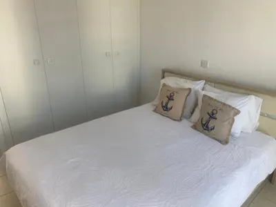 a white bed with two pillows on it at Olive Tree Villa - Protaras in Protaras
