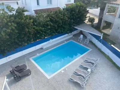 an overhead view of a swimming pool with two lounge chairs at Olive Tree Villa - Protaras in Protaras